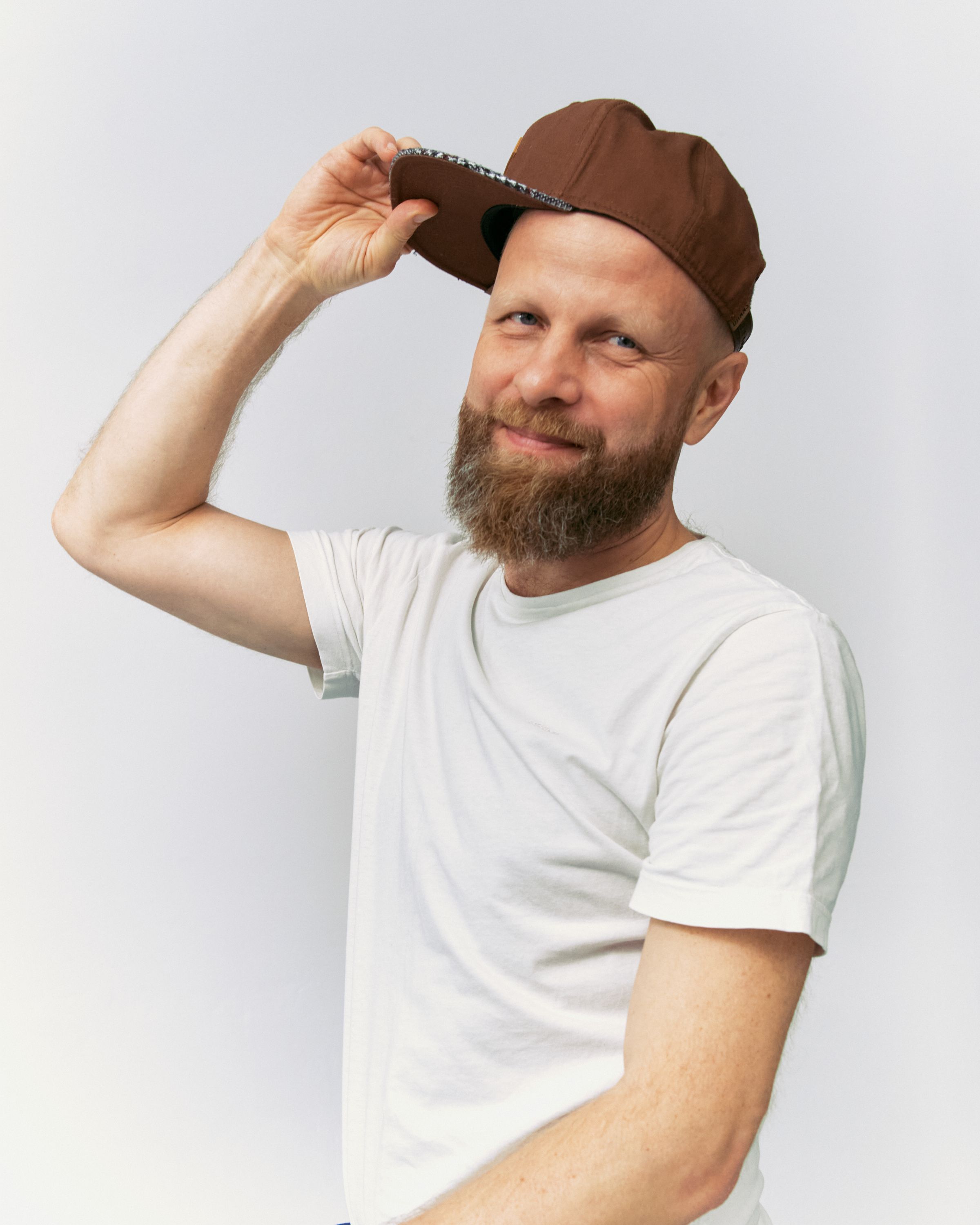 Aliaksei Novikau holding the brim of his cap